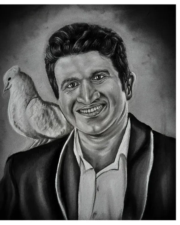 A tribute portrait of the late Kannada superstar Puneeth Rajkumar, known as 'Appu' to his fans. This artwork, made with charcoal and white stone powder, captures his warm smile and has been a meaningful piece for his admirers.