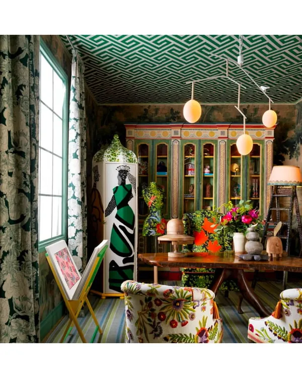 A masterclass in layering, this room is a testament to the power of pattern and texture. I help clients achieve this harmony by curating elements like the geometric wallpapered ceiling, richly embroidered chairs, and statement textiles that coexist in effortless, eclectic style.