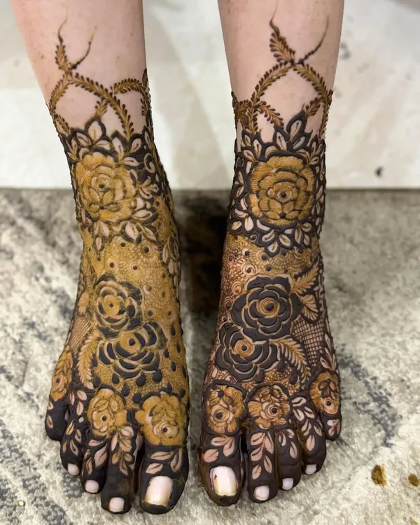 A stunning floral design for the feet, featuring bold roses that cover the top of the foot and extend up the ankle in a delicate vine. This is a perfect choice for a bride who loves floral motifs.