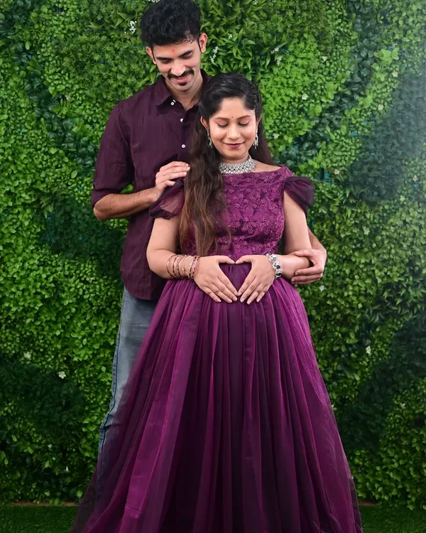 A beautiful moment between parents-to-be during their maternity shoot. The mother is wearing a lovely off-shoulder purple gown from my rental collection, perfect for indoor studio sessions.