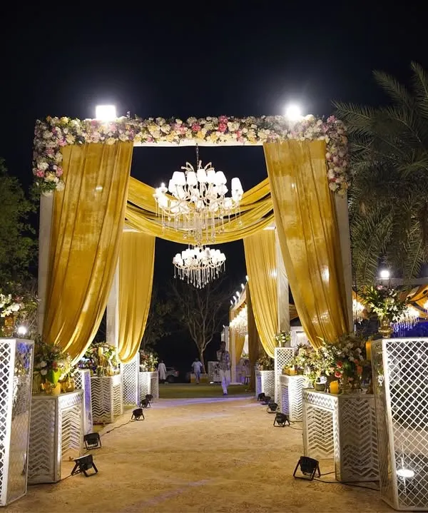 We believe every great love story deserves a grand entrance. This surreal golden gateway, with its cascading drapes and shimmering chandeliers, was designed to feel like stepping into a fairytale, setting the tone for a night of pure grandeur.