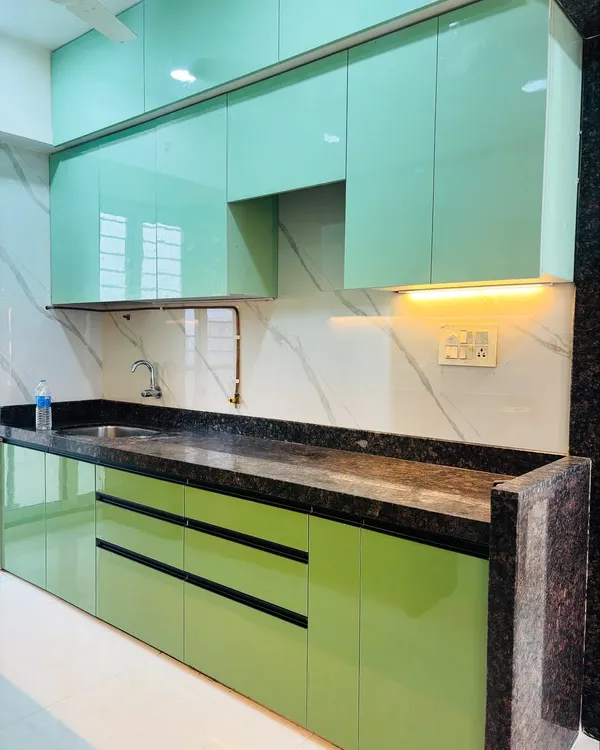 This parallel kitchen features mint green high-gloss cabinets for a fresh and modern look. I've paired it with a dark granite countertop and a white marble-patterned backsplash for a beautiful contrast.