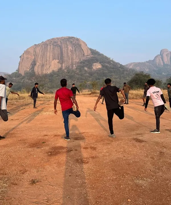 Every great climb starts with a proper warm-up. Participants in our basic course stretch against the iconic backdrop of Ramanagara's rock formations, preparing their bodies for the day's activities.