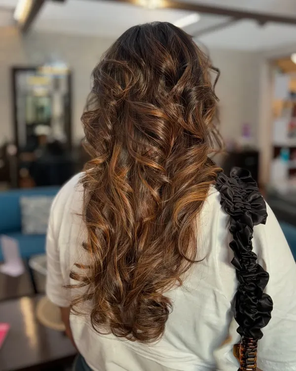 This beautiful caramel balayage is one of our signature looks. The warm tones are hand-painted to create a natural, sun-kissed effect with gorgeous dimension.
