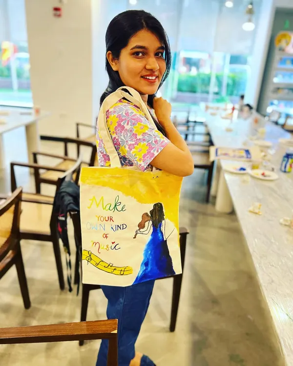 A participant proudly displays her hand-painted tote bag. These workshops are one of my most popular offerings, as everyone creates a unique and practical item to take home.