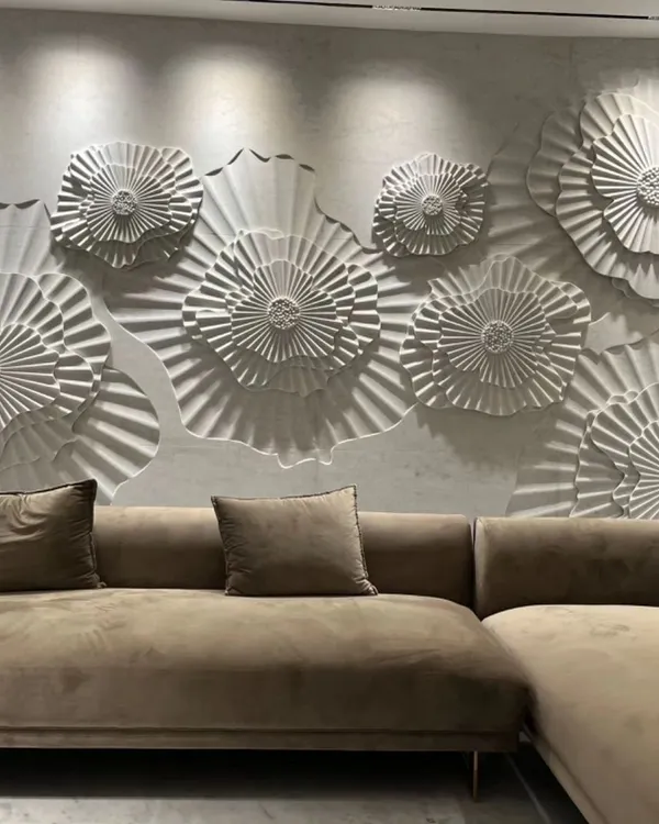 A living room wall brought to life with a custom 3D floral mural from our 'Layers' collection by World of Stones. The deep carvings create dramatic shadows, making the wall a dynamic focal point.