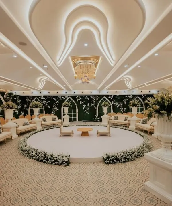 This stunning white-themed engagement ceremony decor radiates subtle chicness. The circular stage and surrounding lounge seating create an intimate and magical ambiance for a timeless celebration.