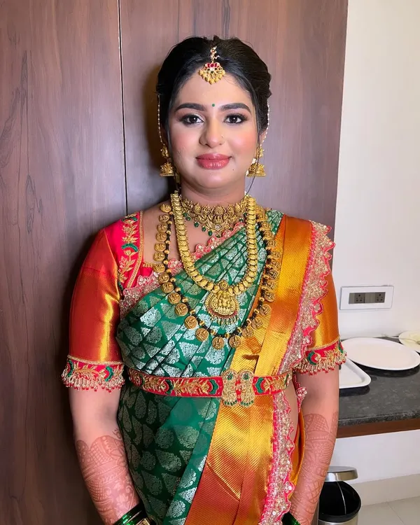 This is the look of pure joy for a Seemantham. I focused on creating a flawless, radiant HD makeup base that glows in person and on camera, paired with traditional gold jewelry and a classic South Indian hairstyle.