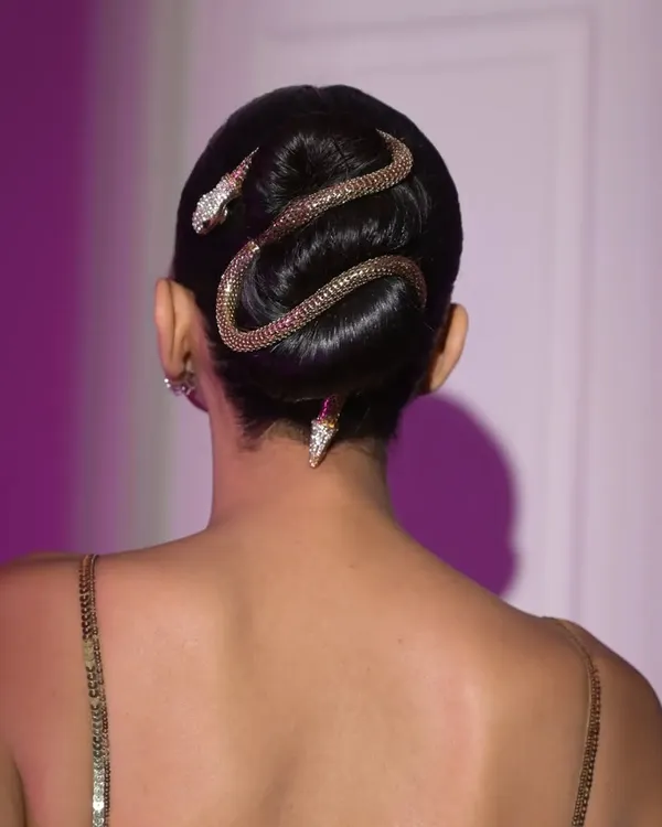 For this high-fashion shoot, I designed a sleek, sculptural bun. The look is elevated with a statement snake hair accessory, creating a bold and memorable editorial hairstyle that is both artistic and camera-ready.