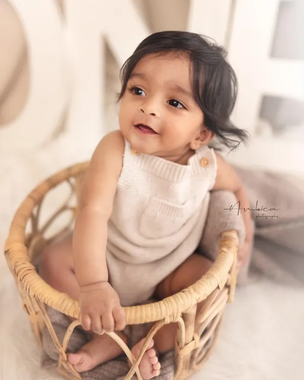 The sitter session is my favorite. This little one, sitting up confidently in a wicker basket, shows off his bright, happy personality. This age is full of smiles and curiosity.