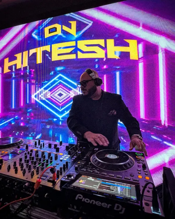 This is my zone. Behind the decks, in front of a massive LED screen, ready to drop the beat for a huge wedding party. I make sure the production is as epic as the music.