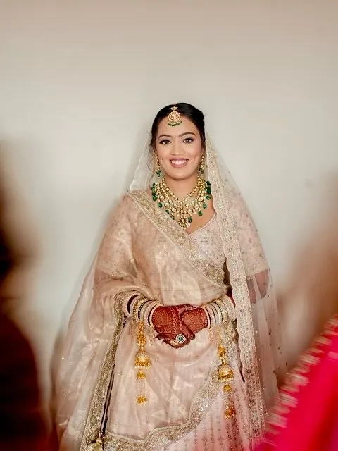 There is unmatched beauty in minimalism. For this bride's ivory lehenga, we chose a fresh, radiant look rooted in elegance, combining soft glam with a hint of tradition for a glow that shines in every frame.