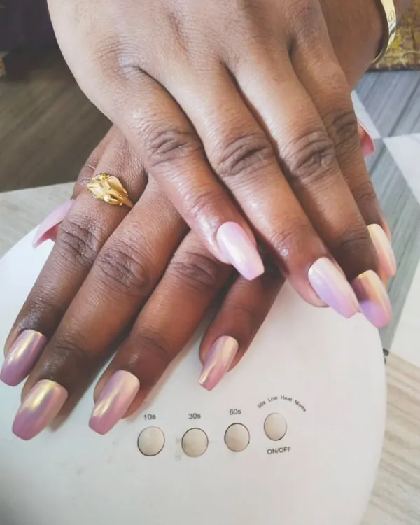 You can never go wrong with a beautiful chrome finish. Here, I've applied a stunning iridescent pink chrome powder over coffin-shaped gel extensions. The way it catches the light is just amazing, and it’s all cured perfectly under my portable UV lamp.