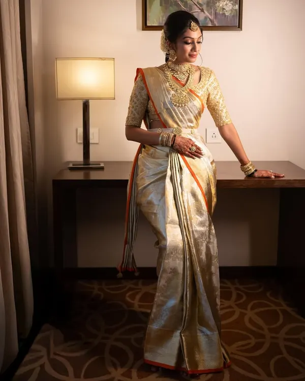 Our bride Hima looking absolutely radiant for her muhurtham. I designed the hand-embroidered blouse to match her stunning gold tissue Kanjeevaram saree, creating a look of pure elegance.