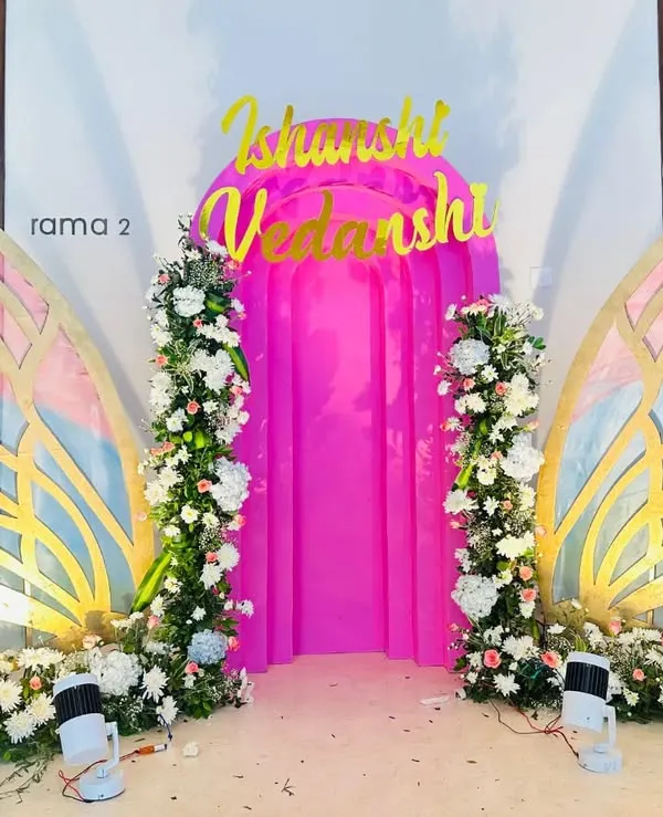 These large, custom-built butterfly wings serve as a unique, interactive photo backdrop. Decorated with artificial flowers and featuring a pink curtained entrance, they create a magical photo opportunity.