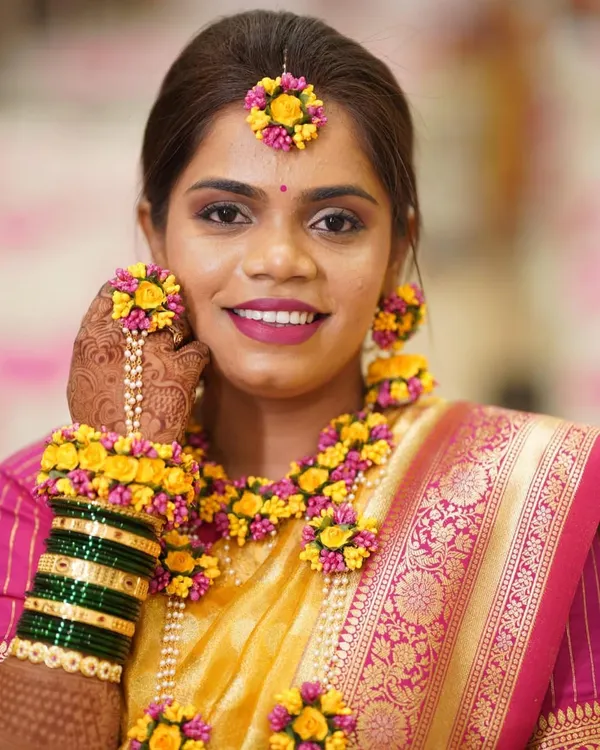 A radiant Haldi bride ready for her ceremony. I created a soft, glowing makeup look and she paired it with beautiful fresh floral jewelry.