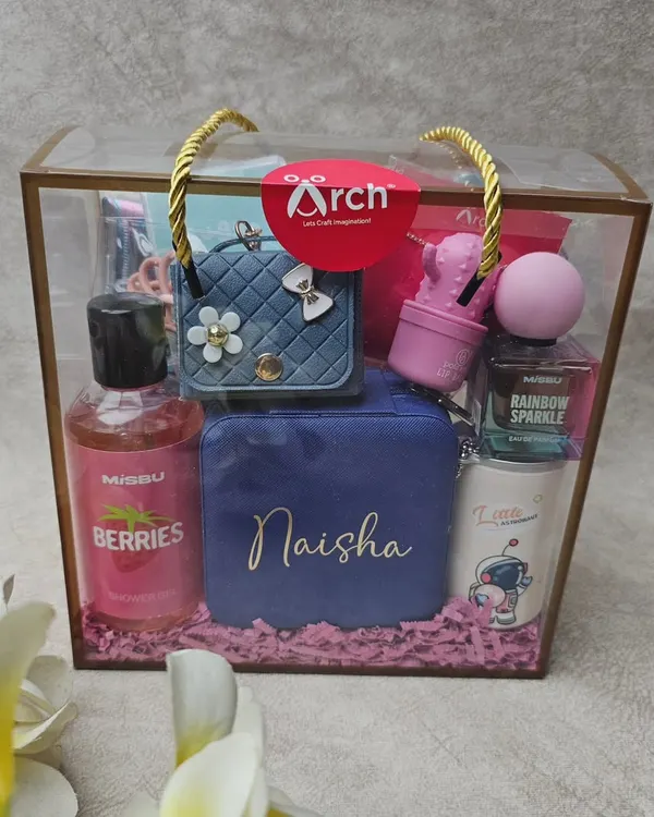 A beautiful, custom-packed hamper ready to delight. This one, created for a sister, includes a personalized jewelry box, body care products, a cute mug, and other fun accessories, all presented in a clear tote bag.