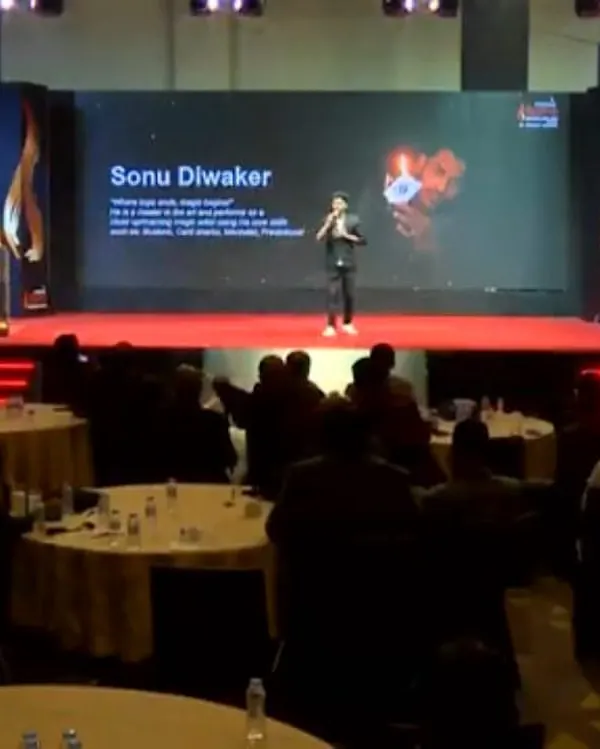 Performing on a grand stage for a corporate summit. The combination of professional lighting, large screen visuals, and my act creates a powerful and immersive experience for every attendee.