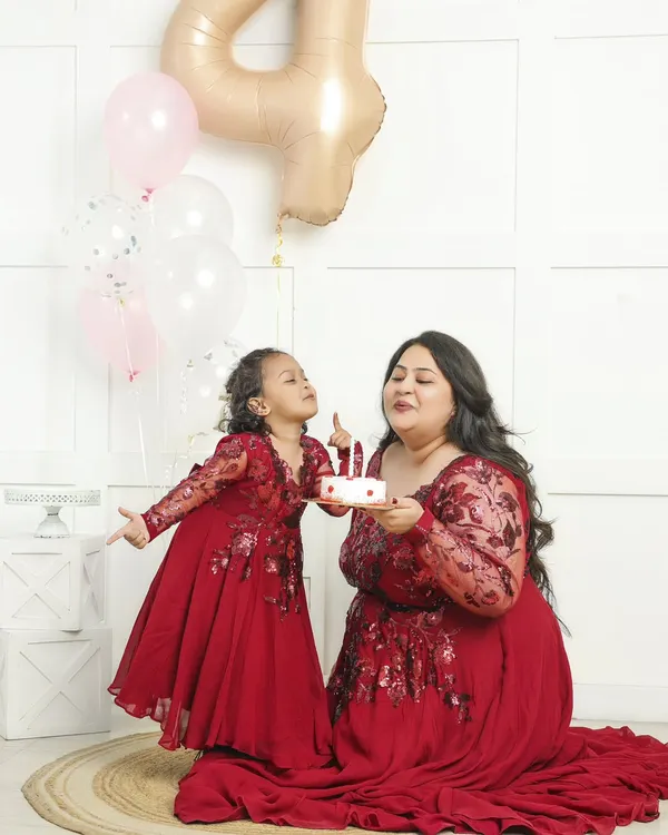A mother and daughter celebrating a birthday together. Capturing this bond in matching dresses creates a memory that both will treasure forever.