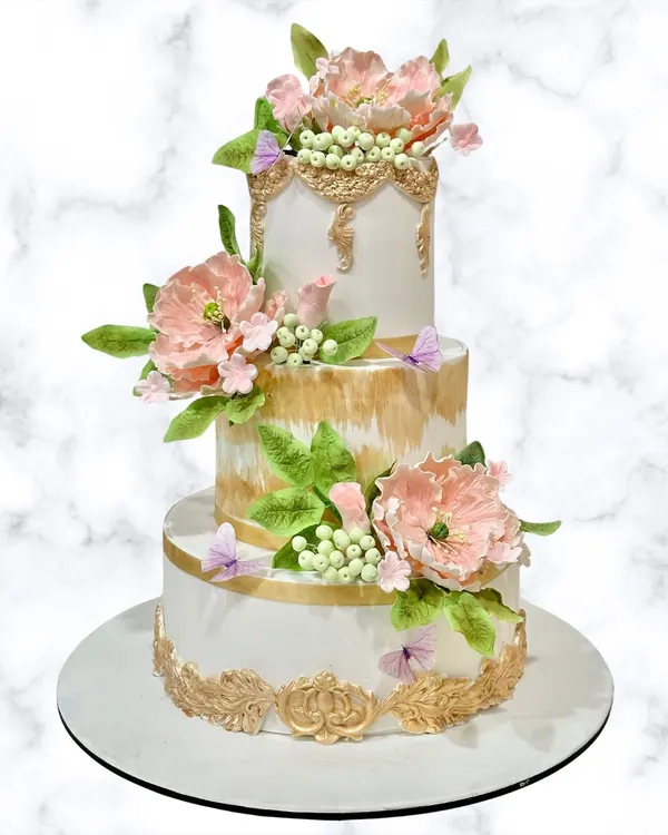This three-tiered floral masterpiece is where my passion for detail and elegance comes to life. Each sugar flower is handcrafted, making your celebration cake a true work of art.