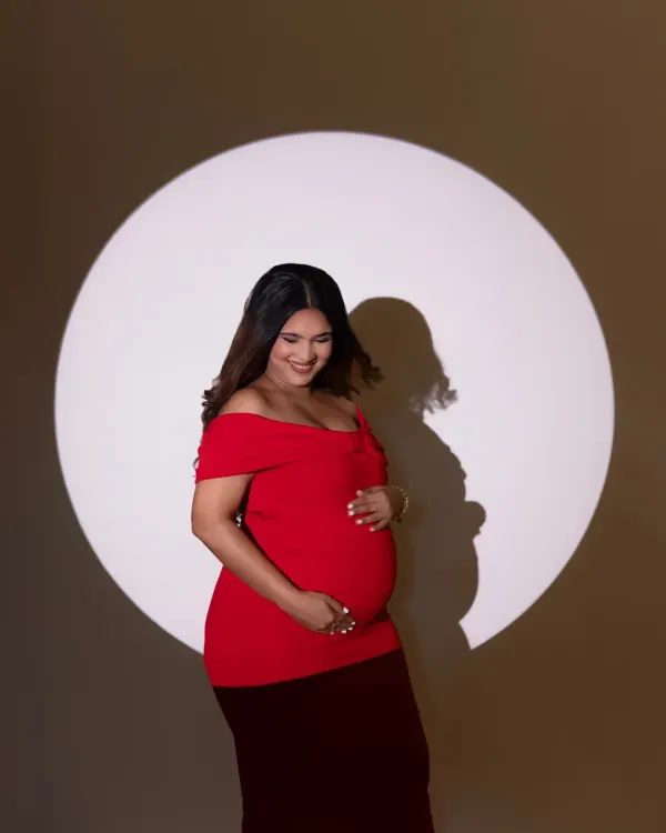 Using a single spotlight, I can create a sense of drama and focus entirely on the mother-to-be. This portrait of Ruchika in a bold red dress is a perfect example of how simple, powerful lighting can create a striking and elegant maternity photo.