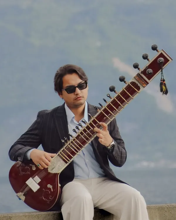 A playful moment in Lausanne, Switzerland, inspired by the "Peaky Blinders" style. It shows my contemporary side and the joy I find in blending tradition with modern aesthetics, whether in music or in life.