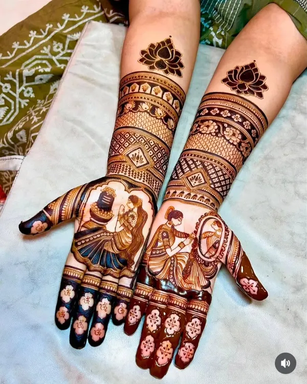 This is a great example of my custom portrait mehandi for a bride. On one palm, I created a design of a woman doing puja, and on the other, a bride looking in the mirror, both surrounded by intricate patterns extending up the full arm.