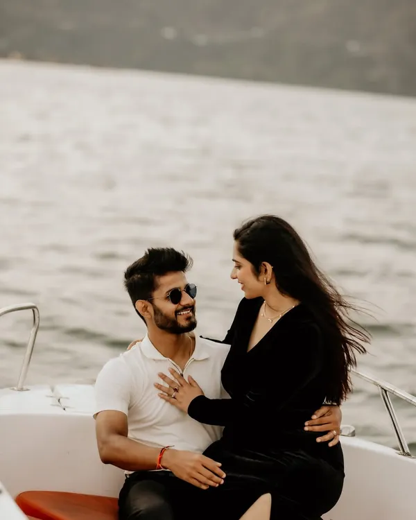 A candid moment on a speedboat, with the wind in her hair as they share a loving look.