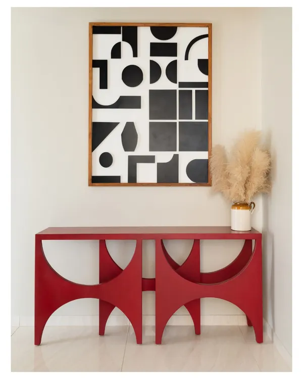 This bright red console table makes a bold statement in the foyer of our Devanahalli project, set against a custom black and white geometric art piece. It’s an unexpected pop of color that welcomes you into the home.