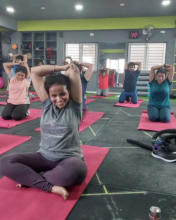 Cooling down with some essential stretches after an intense aerobics session. This tricep stretch helps with upper body flexibility and muscle recovery.