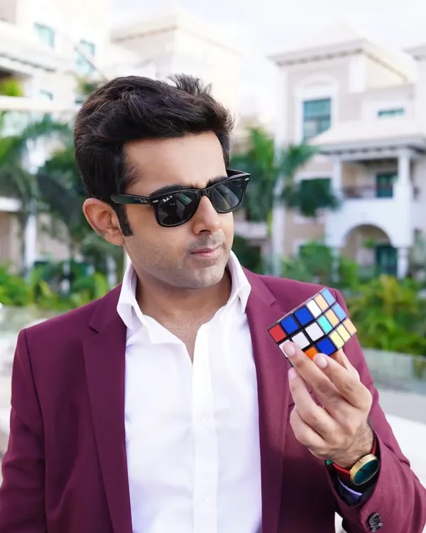 Holding a Rubik's Cube. With 43 quintillion possible combinations, it's a powerful metaphor for the near-infinite possibilities in life. Sometimes you're just one twist away from everything clicking into place.