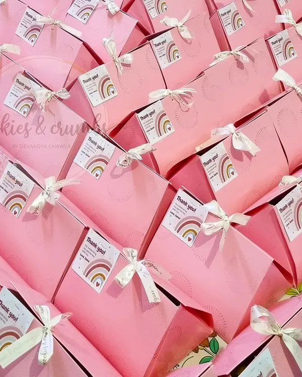 Pretty in pink. These custom goodie bags were prepared as return favors for a first birthday party. Each bag contained a mini tea cake, a cookie, a brownie, and some chocolates.