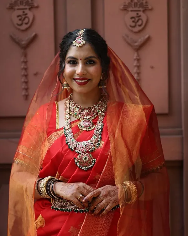 This is what we live for. Seeing a bride look and feel her absolute best on her wedding day. This client is radiant in one of our classic temple jewellery sets, complete with a layered haram, choker, and matching maang tikka, perfect for a traditional South Indian ceremony.