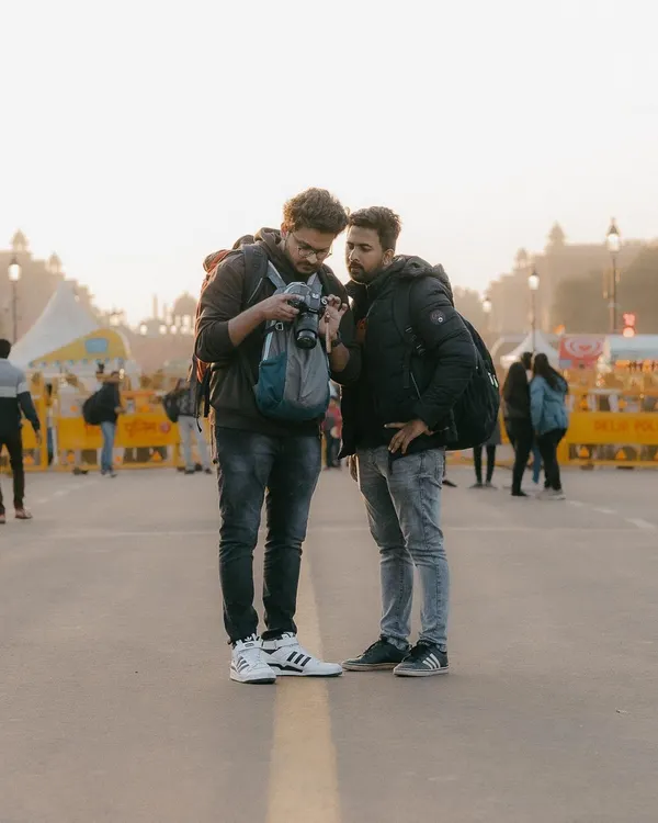 A typical moment during one of our photo walks near India Gate. We'll stop, review the photos you've taken right on the camera, and discuss what's working and how you can improve your composition and settings for the next shot.