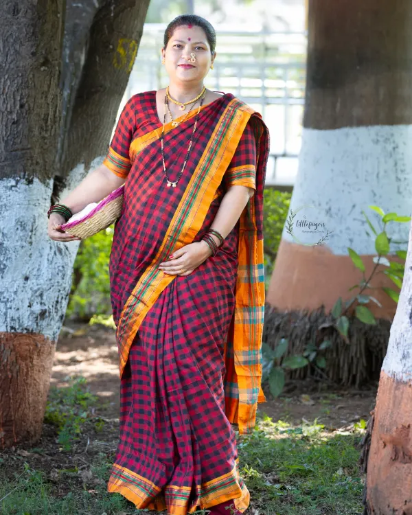 A beautiful solo portrait from a traditional Marathi maternity shoot. The rich colors of the saree and the classic pose celebrate both motherhood and cultural heritage.