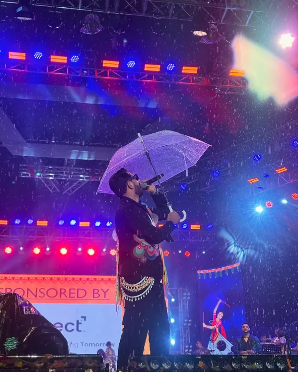 My motto is simple: The Show Must Go On. Here I am, keeping the energy high at the Rangraas Navratri festival even as the rain came down. As a professional event host, I'm always prepared to keep the crowd engaged, no matter the weather.