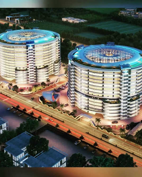 An aerial night view rendering of twin towers designed for a 7-star resort and serviced apartment complex in Surat. The radial design and illuminated crowns are engineered to make this a standout destination.