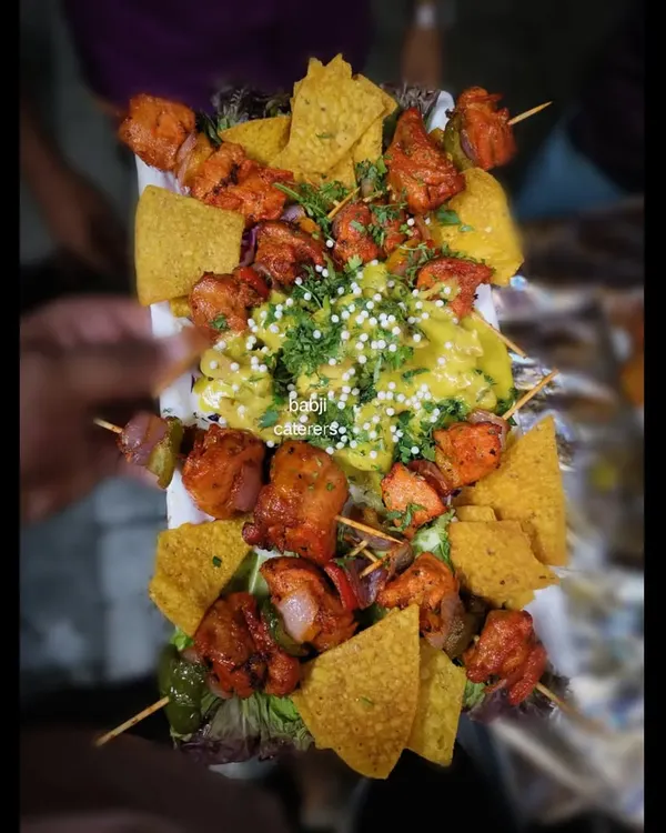 Our Chicken Shashlik with Lebanese chicken, served with nachos. This dish is a fusion of flavors, combining tender grilled chicken with a creamy sauce and crunchy nachos.