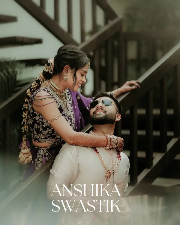 A playful and tender moment captured on the stairs. I love these unscripted interactions, where the bride's embrace and the groom's joyful smile tell a story of comfort and pure happiness.