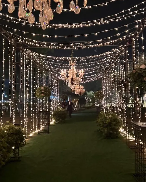 This is the kind of magic I love to create. A sparkling tunnel of fairy lights and chandeliers makes for an unforgettable entrance, setting the perfect tone for a night of celebration.