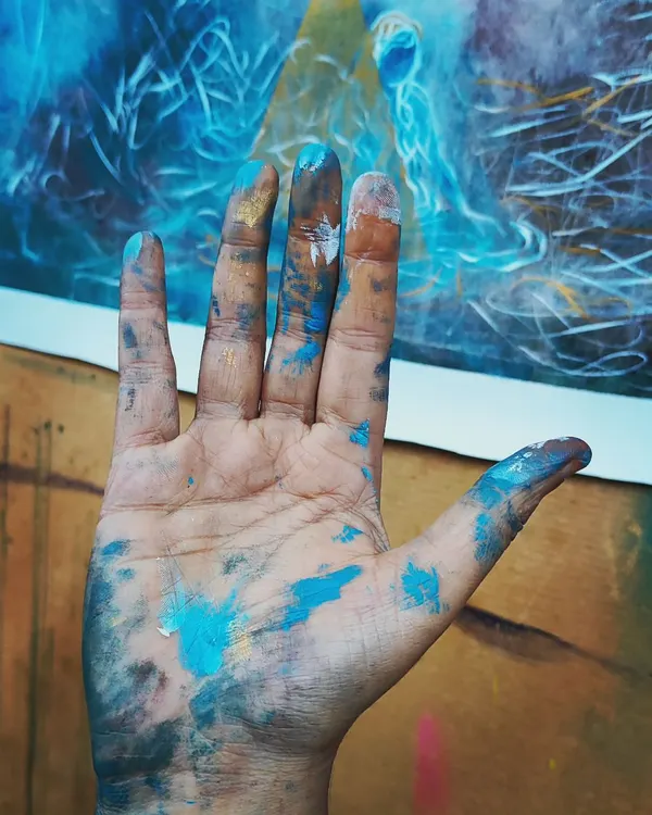 When the Universe holds my hand, it looks something like this. A snapshot of my paint-covered hand in my happy, messy studio after a painting session.