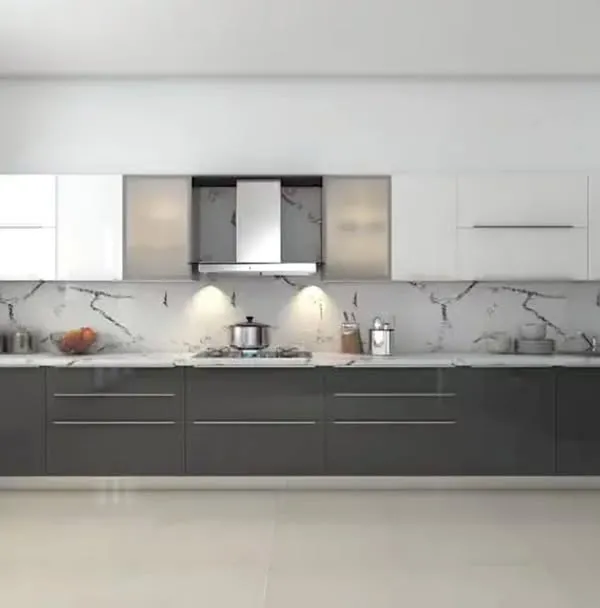 A sleek, ultra-modern straight kitchen with dark grey base cabinets and white uppers. The striking marble-patterned backsplash serves as a dramatic feature wall, elevating the entire design.