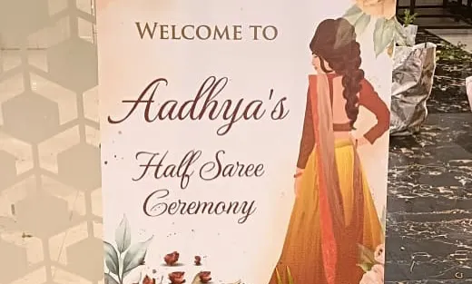 A personalized welcome sign for a Half Saree Ceremony, featuring a custom illustration to celebrate the young woman's milestone.