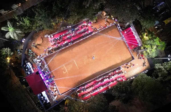 An aerial view of the DPL Season 11 cricket tournament at night. This shot captures the scale of the production, showing the fully illuminated ground, spectator stands, and the main stage, all set up by my team.