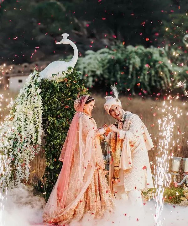 A magical varmala exchange for the couple, framed by a magnificent floral peacock and sparkling cold pyros. This is the kind of unforgettable, fairytale moment I love to create for your special day.