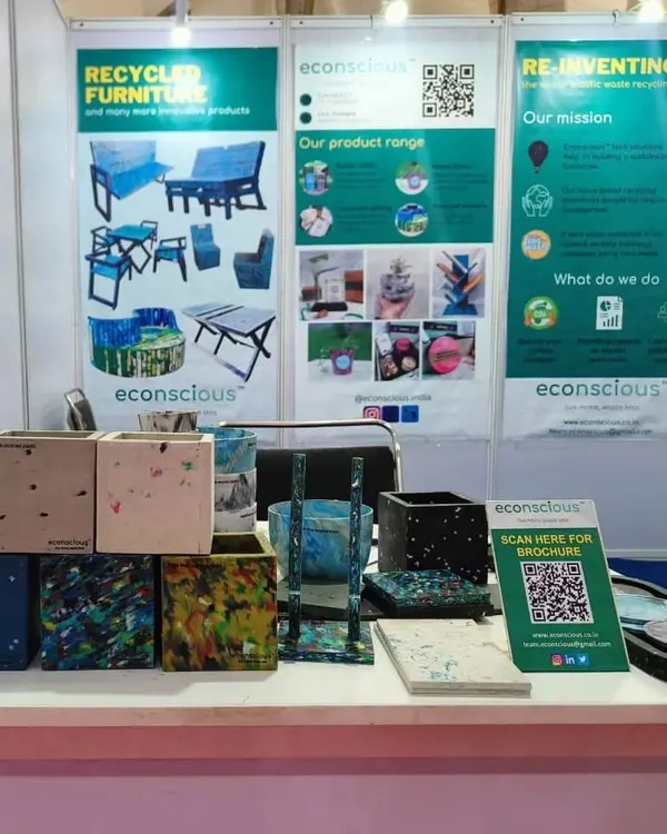 A close-up of our product display at the UP Global Investors Summit. We showcased a variety of our recycled plastic planters, each with a unique color and pattern, along with a QR code for our brochure.