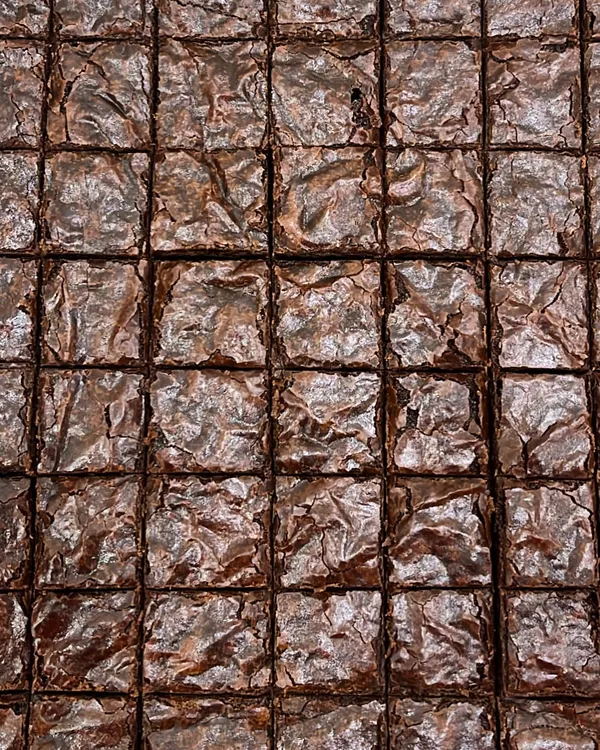 Look at that perfect crinkly top. Our brownies are incredibly fudgy and gooey, and they're made without any eggs or refined sugar.