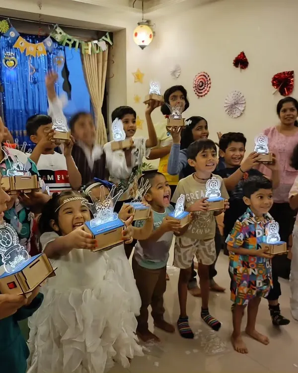 Look at these proud inventors! In our workshops, every child gets to build and take home their own creation, like these amazing custom light-up lamps. It's a glowing reminder of what they can achieve.