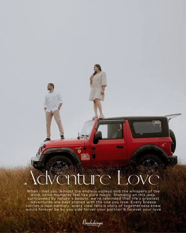 A couple stands atop a red jeep overlooking a vast, grassy valley, perfectly capturing the spirit of an "Adventure Love" story. This is for couples who want an epic and adventurous pre-wedding shoot.