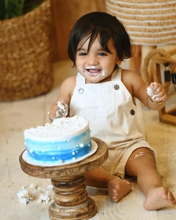 The perfect shot of a baby boy's joyful and messy cake smash. Milestone sessions like this are a fantastic way to celebrate a first birthday.